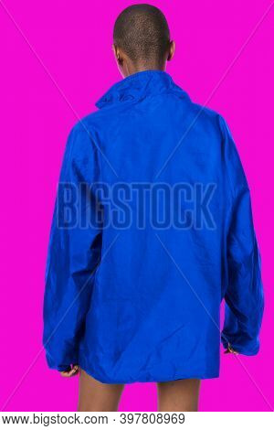 Black woman wearing a blue waterproof jacket mockup on a fluorescent pink background