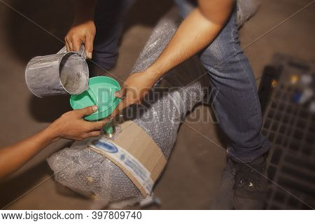 Technician Team Uses Liquid Coolants A11 Pour The Liquid Into The Oil Device. Cooller To Clean Sedim