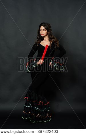 Portrait Of Beautiful Young Woman Dancing Flamenco In Studio