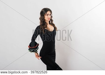Portrait Of Beautiful Young Woman Dancing Flamenco In Studio