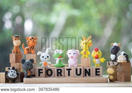 Cute Animal In The Chinese Zodiac With Wood Block Text With Fortune. Concept Of Fortune In Life