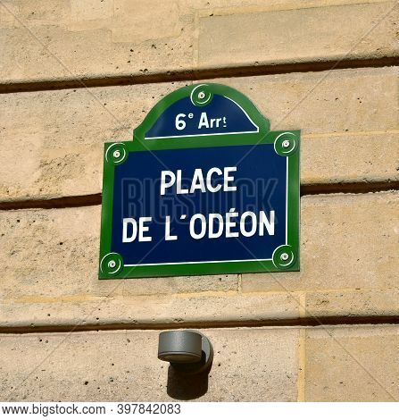 Place De L'odeon Street Sign Close-up. Paris, France. Text: 6th District. Square Of The Odeon.