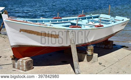 Portosin, Spain. July 5, 2020. Old Galician Wooden Rowboat In A Harbor. Coruña Province, Rias Baixas