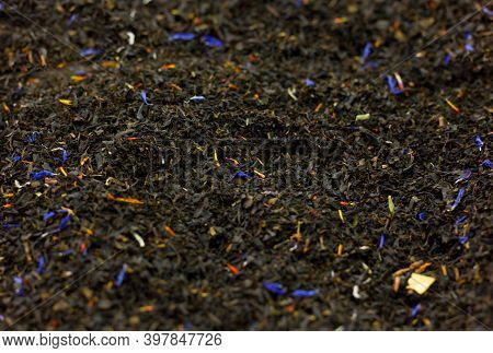 Selected Black Large Leaf Tea With The Addition Of Dried Flowers And Herbs In Bulk Close-up Backgrou