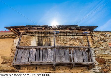 Old Vintage Wooden Balcony Under Starry Sun And Blue Sky