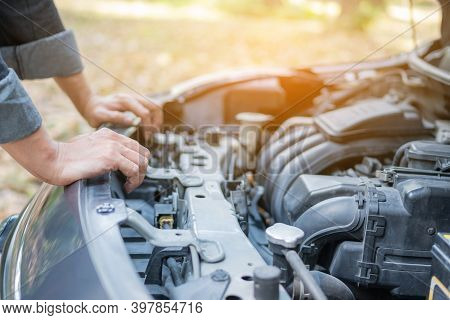 Close Up Hand Man Open Car Hood For Repair As Maintenance Service. Man Trying To Repair A Car Engine