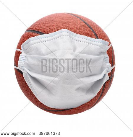 Covid-19 and Sports Concept. A basketball with Surgical Mask, isolated onb white