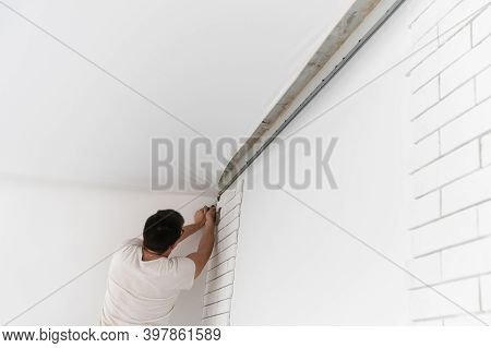 Stretch Ceiling. Workers Stretch The Suspended Ceiling In The Room. Ceiling Installation.