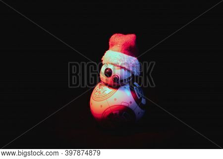 Caba, Argentina, November 28, 2020: Lovely Droid Bb-8 From Star Wars, Wearing A Christmas Hat In Dar
