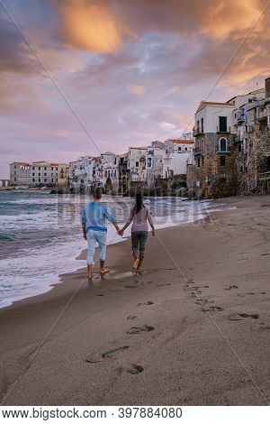 Cefalu, The Medieval Village Of Sicily Island, Province Of Palermo, Italy. Europe, A Couple On Vacat