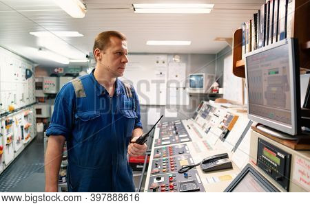 Marine Engineer Working On Radio Communication At Engine Control Room Ecr