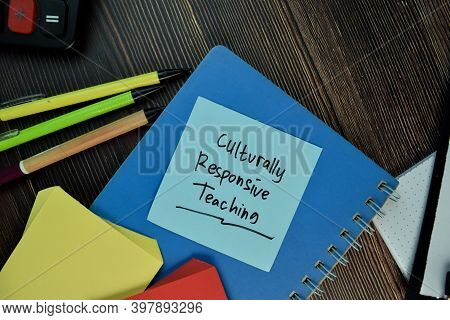 Culturally Responsive Teaching Write On Sticky Notes Isolated On Wooden Table.