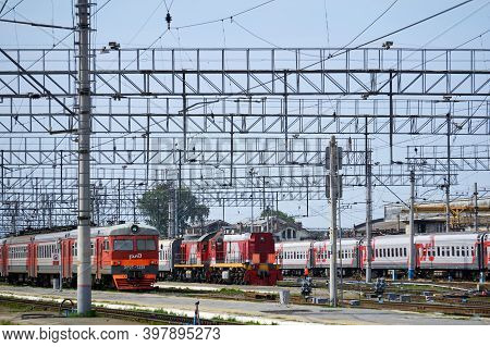 Perm, Russia - August 07, 2020: Intercity And Regional Passenger Trains On The Tracks Near The Platf