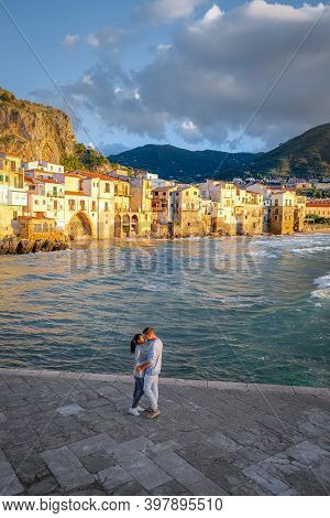 Cefalu, The Medieval Village Of Sicily Island, Province Of Palermo, Italy. Europe, A Couple On Vacat