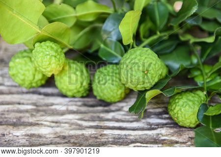 Fresh Bergamot Fruit , Kaffir Lime, Citrus Bergamia With Leaf On Wooden Table, Slice Bergamot Citrus
