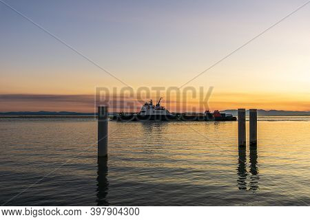 Richmond, Canada - September 10, 2020: Seaspan Ferry On The Fraser River Sunset Time In British Colu