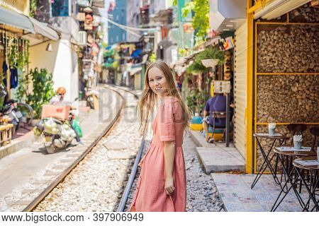 Woman Is Walking Of Hanoi City Railway. Perspective View Running Along Narrow Street With Houses In 