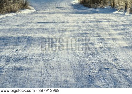 Tire Tracks Left In The Snow On A Bright Sunny Day. The Concept Of Snow Removal, Ski Resorts, Active