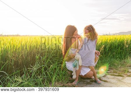Young Mother And Daugther Hug Near Rice Field, Nature, Travel