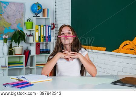 High School. Cheerful Kid Learning Subject. Modern Education. Knowledge Day. Child Pupil Sit At Tabl
