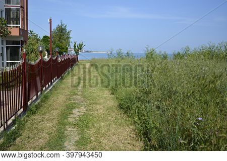 Ravda, Bulgaria. May 24 2014. Boundary Between Well-groomed Residental Yard Surrounded By Fence And 