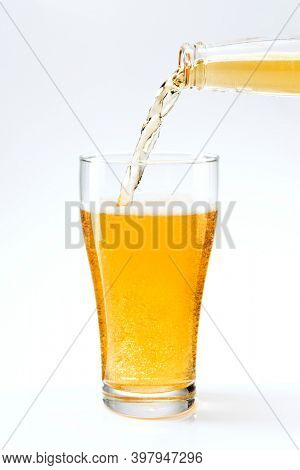 Beer pouring into apint glass from a beer bottle