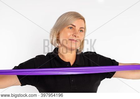 Portrait Of A Sportive Woman With A Fitness Elastic Band. White Background.