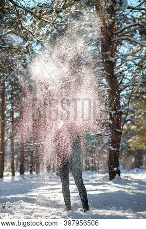 Woman In Winter Forest Surrounded By Snowflakes.