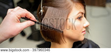 Professional Hairdresser Brushing Straight Female Hair While Hair Care Beauty Procedures In A Hair S