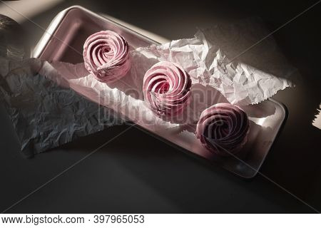 Pink Strawberry Homemade Zephyr Or Marshmallow In A Rectangular Oleum Plate In The Sun On The Table.