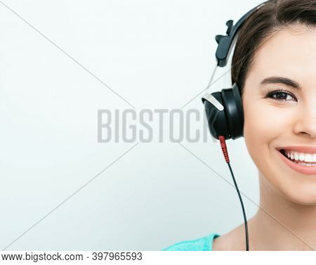 Mixed Race Woman With Toothy Smile Getting A Hearing Test, Audiometer Hearing Test. Half Face, On Gr