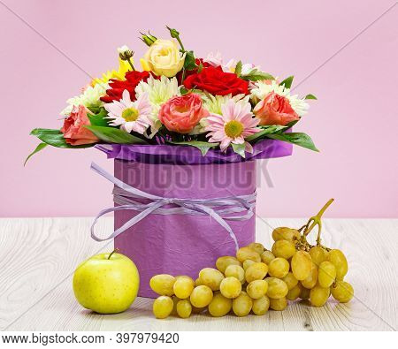 Bouquet Of Wildflowers, Graps And An Apple On The Wooden Boards.