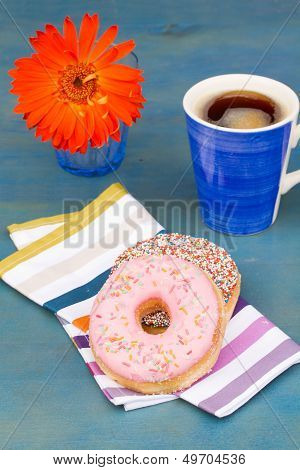 breakfast with black coffee and two donuts