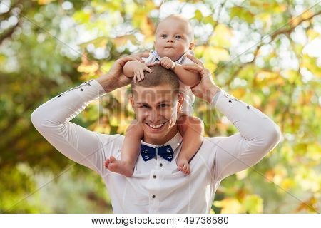 Happy Young Man Holding A Smiling 7-9 Months Old Baby