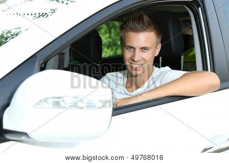Young man in his new car