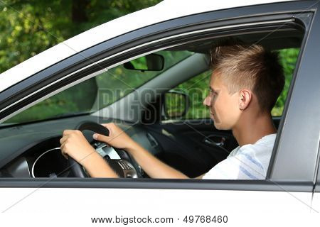 Young man in his new car