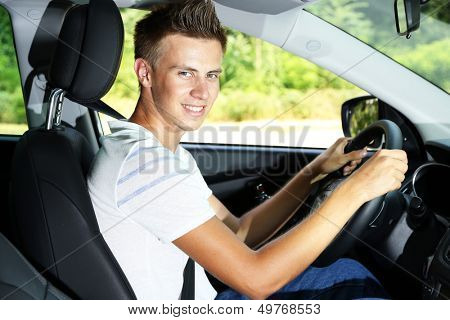 Young man in his new car