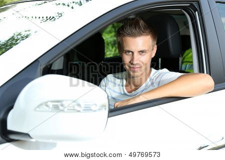Young man in his new car