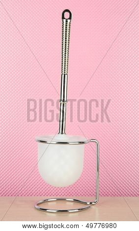 Toilet brush on pink background