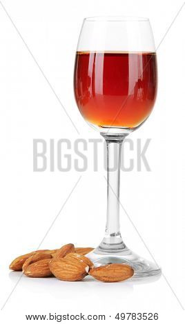 Glass of amaretto liquor and roasted almonds, isolated on white