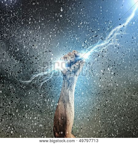 Human hand holding lightning