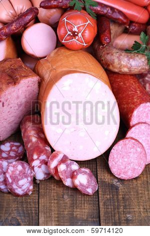 Lot of different sausages on wooden table close-up