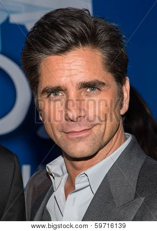 NEW YORK-JAN 29: Actor John Stamos (R) visits the Dannon Oikos Tent on Park Avenue on January 29, 2014 in New York City.