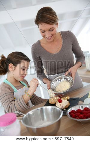 Mother and daughter preparing cream puffs