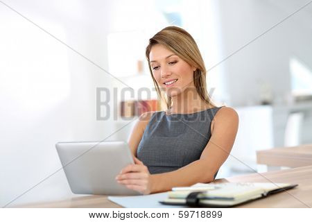 Businesswoman in office working on digital tablet