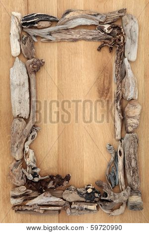 Driftwood abstract border on oak wood background.