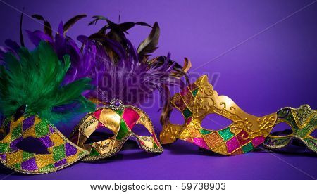 Festive Grouping of mardi gras, venetian or carnivale mask on a purple background