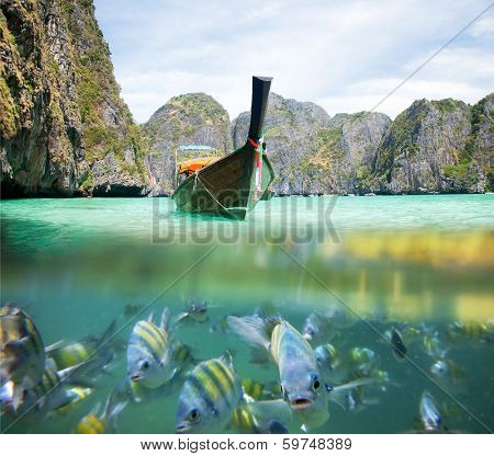 Underwater picture with fish and traditional longtail boat in Maya bay, Ko Phi Phi Le, Tailand