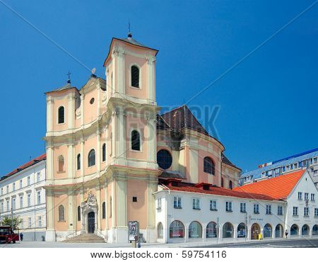 Side View Of Trinitarian Church And The Passers-by On The Street, Bratislava, Slovakia