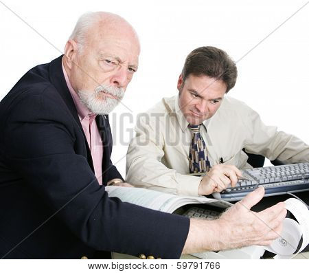 Wealthy senior man with his accounant, looking upset by his large tax bill.  White background